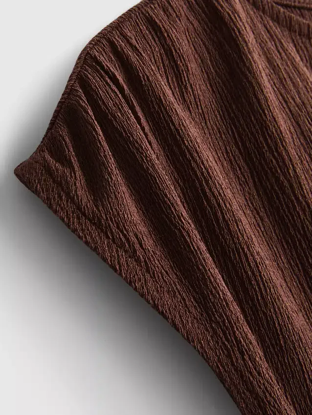 Asymmetric crinkle top