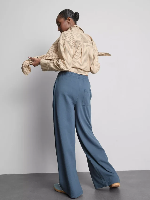 Cotton-rich wide-leg pleated joggers