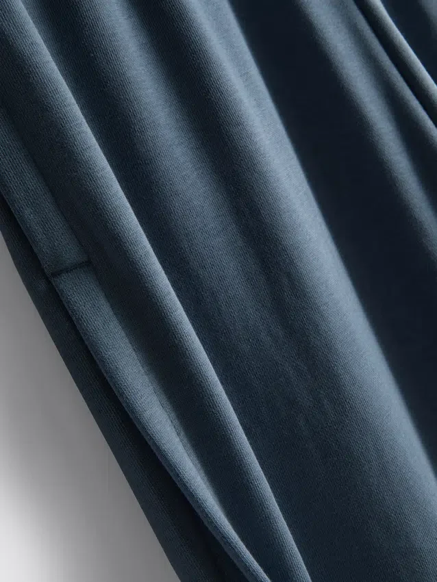 Cotton-rich wide-leg pleated joggers