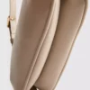 Curved faux leather shoulder bag