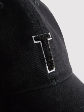 Tufted initial cap