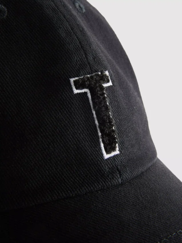 Tufted initial cap